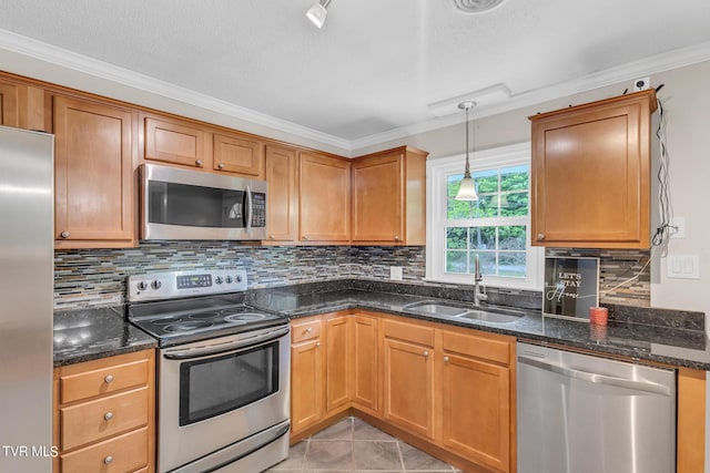 kitchen featuring stainless steel appliances, backsplash, sink, light tile floors, and pendant lighting