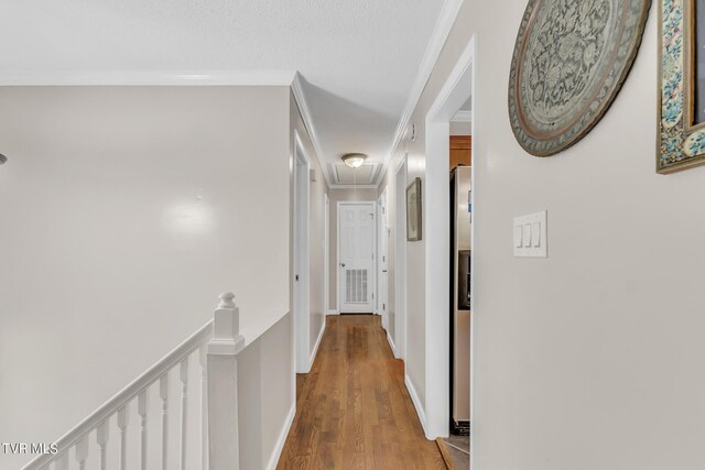 hall with ornamental molding and hardwood / wood-style flooring