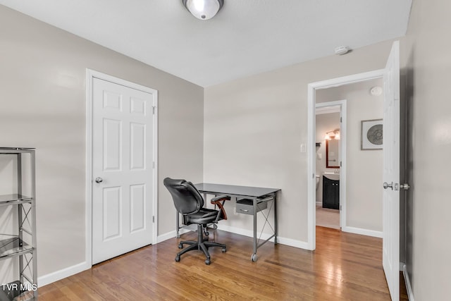 office with light wood-type flooring