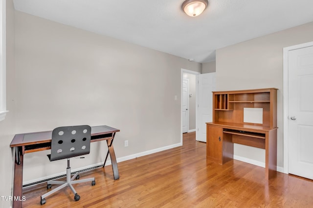 office with light hardwood / wood-style flooring