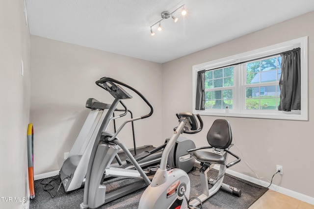 workout area featuring rail lighting