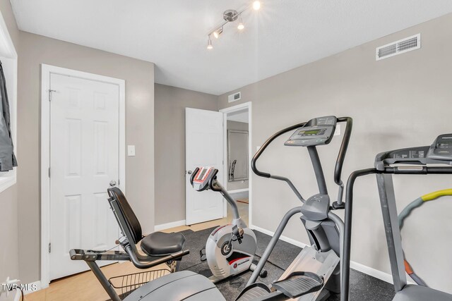 workout room with rail lighting