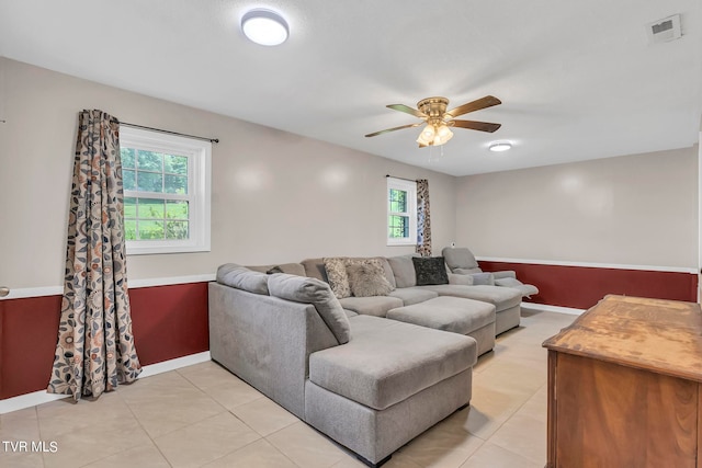 living room with ceiling fan, a healthy amount of sunlight, and light tile flooring