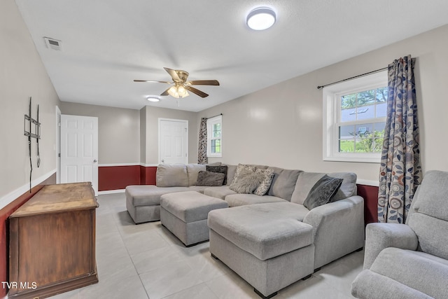 living room with ceiling fan and light tile floors