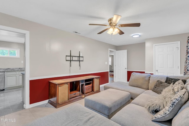 tiled living room featuring ceiling fan