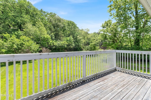 wooden terrace featuring a lawn