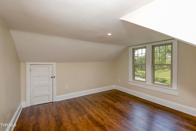 bonus room with wood-type flooring and vaulted ceiling