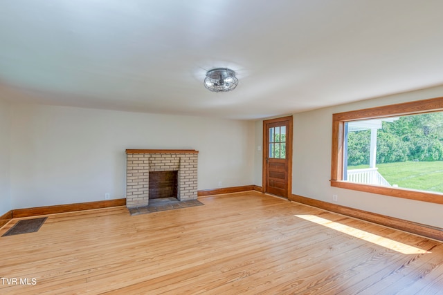 unfurnished living room with light hardwood / wood-style flooring and a fireplace