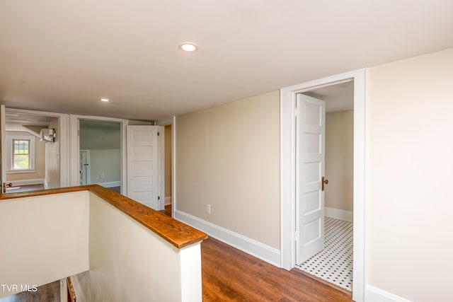 hall with dark hardwood / wood-style flooring