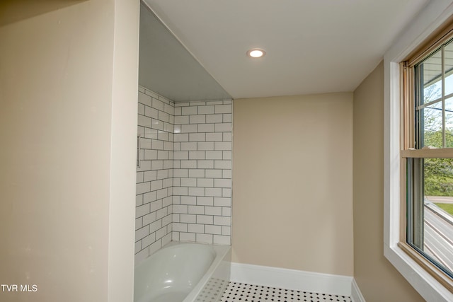 bathroom featuring tiled shower / bath and tile flooring