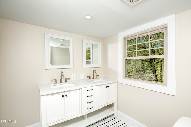 bathroom with plenty of natural light, tile floors, double sink, and large vanity