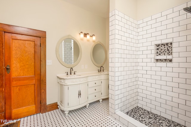 bathroom with tile flooring, double vanity, and a tile shower