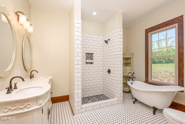 bathroom featuring dual bowl vanity, tile floors, toilet, and a tile shower