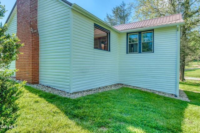 view of side of home with a yard