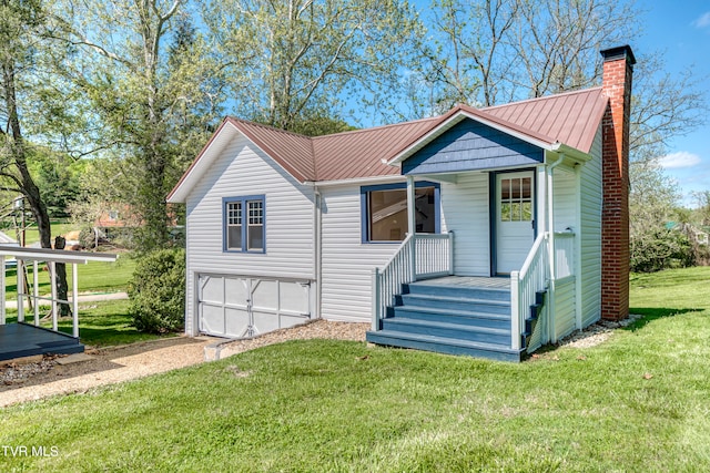 view of front of house with a front yard, a carport, and a garage