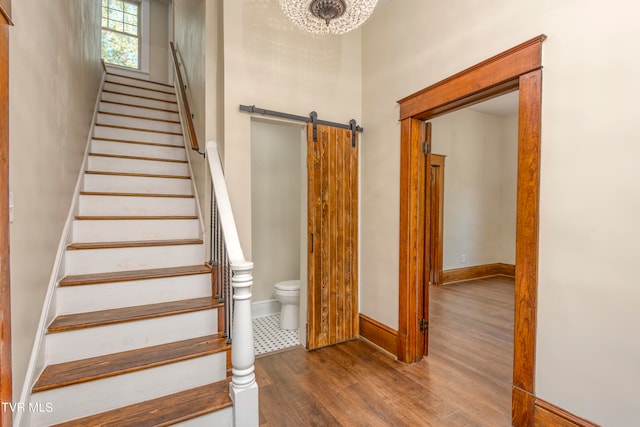 stairway featuring hardwood / wood-style floors and a barn door