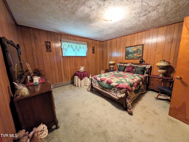 carpeted bedroom featuring wood walls, baseboard heating, and a textured ceiling