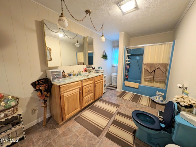 bathroom with tile patterned flooring, ornamental molding, and a textured ceiling