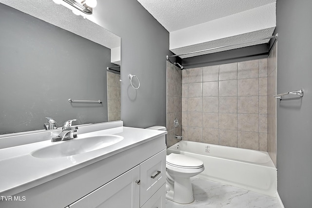 full bathroom with vanity, a textured ceiling, tiled shower / bath combo, and toilet