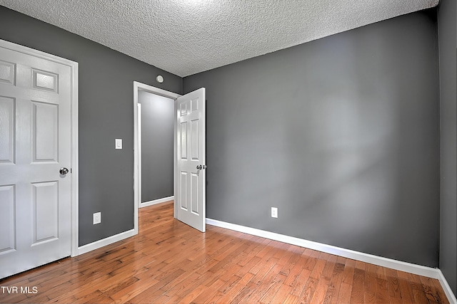 unfurnished bedroom featuring light hardwood / wood-style floors and a textured ceiling