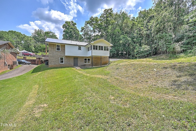 rear view of property featuring a yard