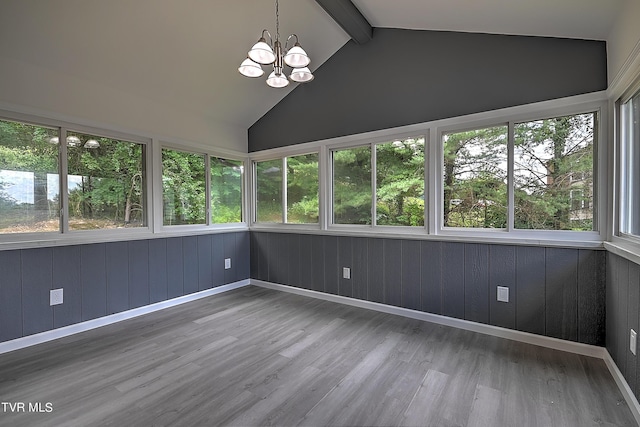 unfurnished sunroom featuring a notable chandelier and vaulted ceiling