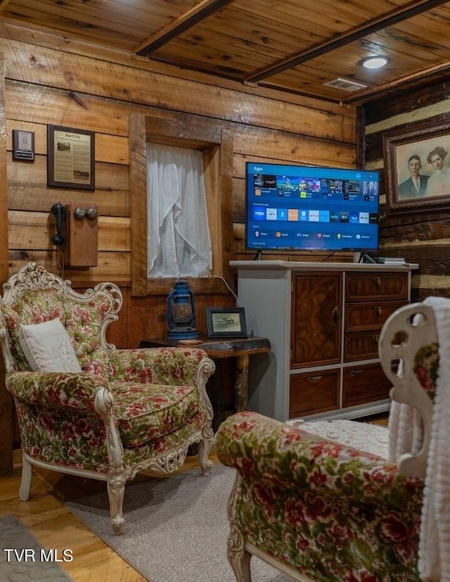 living room featuring wood-type flooring, wooden walls, and wood ceiling