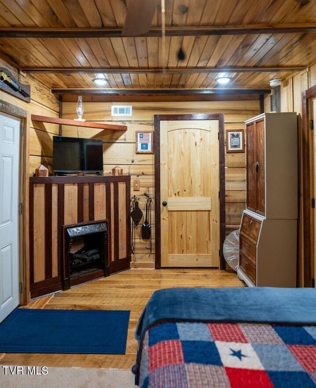 bedroom featuring hardwood / wood-style floors, wooden walls, and wood ceiling