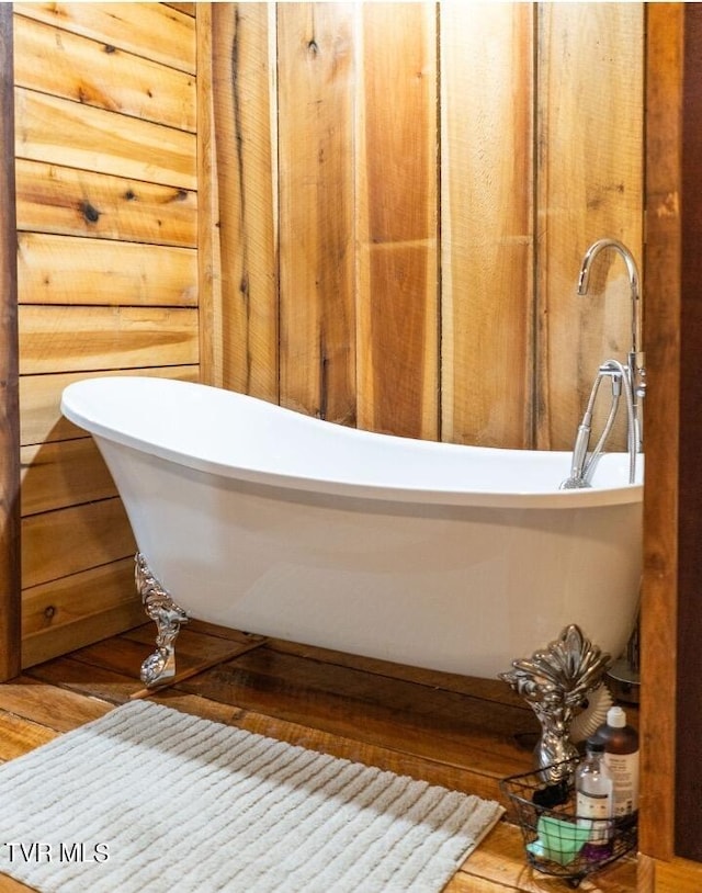 bathroom featuring a bath and hardwood / wood-style floors