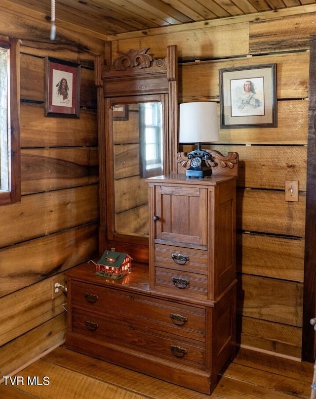 room details with wooden ceiling, wooden walls, and hardwood / wood-style floors