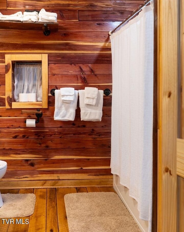 bathroom with hardwood / wood-style floors and toilet