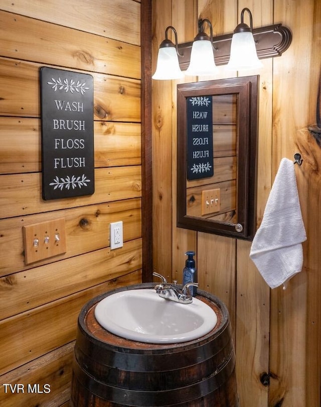 bathroom with wood walls and oversized vanity