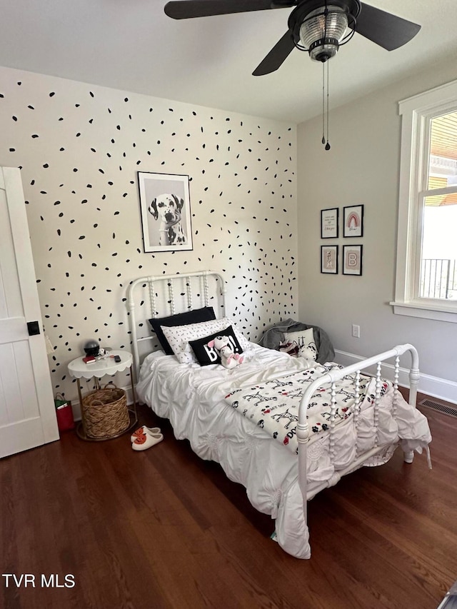 bedroom with ceiling fan and dark wood-type flooring