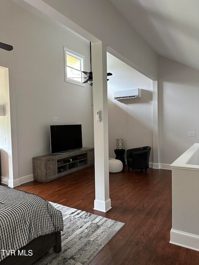 bedroom featuring dark wood-type flooring and a wall mounted AC