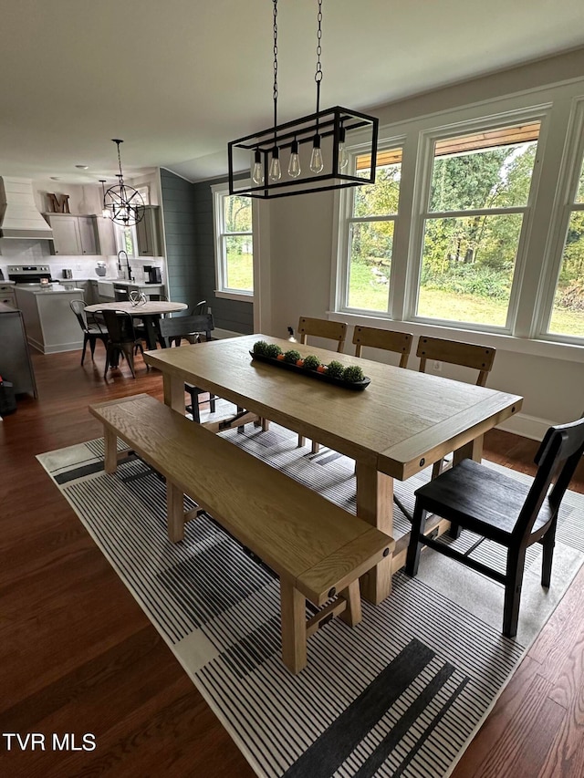 dining area featuring a notable chandelier and light wood-type flooring