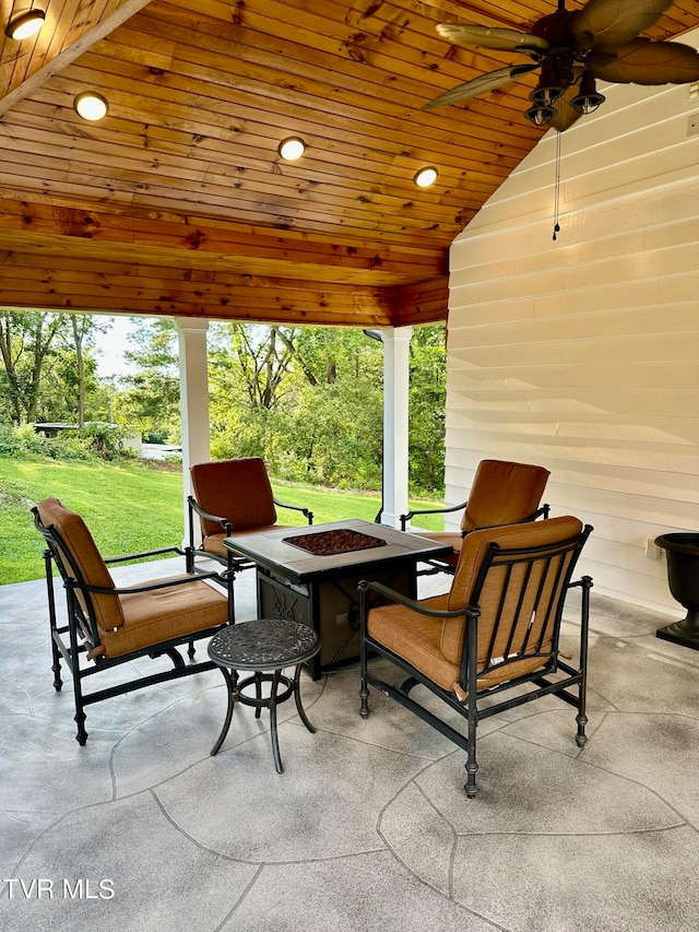 view of patio featuring ceiling fan and a fire pit