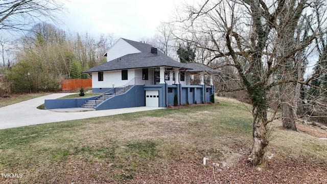 back of property with a garage and a yard