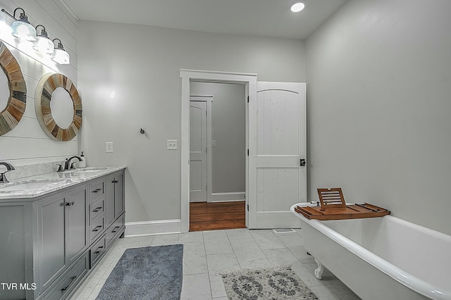 bathroom with a tub and vanity