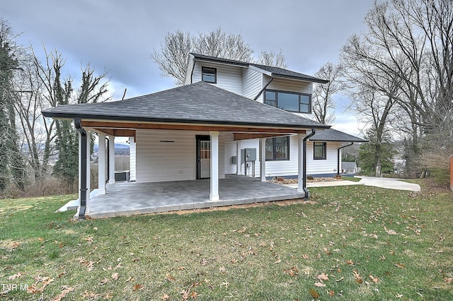 rear view of property with a yard and a patio