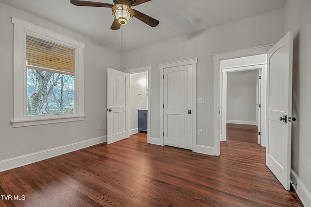 unfurnished bedroom featuring dark hardwood / wood-style floors and ceiling fan