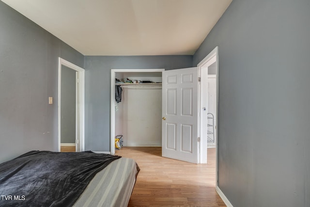 bedroom with a closet and light wood-type flooring