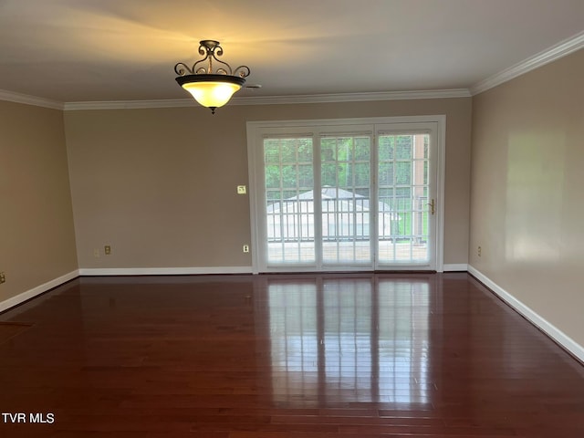 unfurnished room with ornamental molding and dark hardwood / wood-style floors