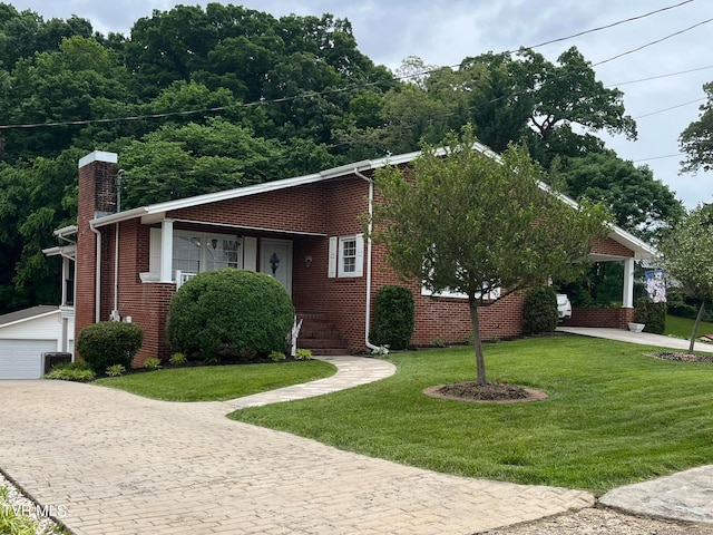 view of front of house with a front yard and a garage