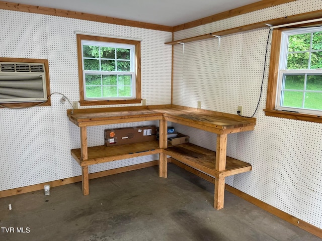 miscellaneous room with concrete flooring and a wall mounted air conditioner