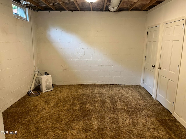 basement featuring dark colored carpet