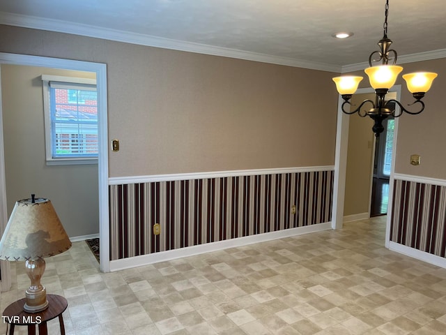 tiled empty room featuring an inviting chandelier and crown molding