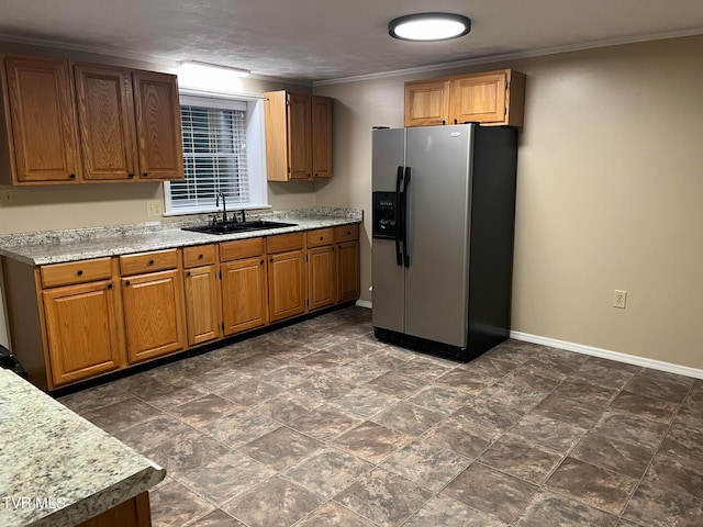 kitchen featuring stainless steel refrigerator with ice dispenser, sink, dark tile floors, and ornamental molding