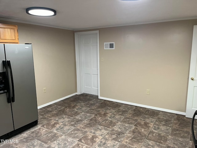 interior space featuring dark tile flooring and ornamental molding