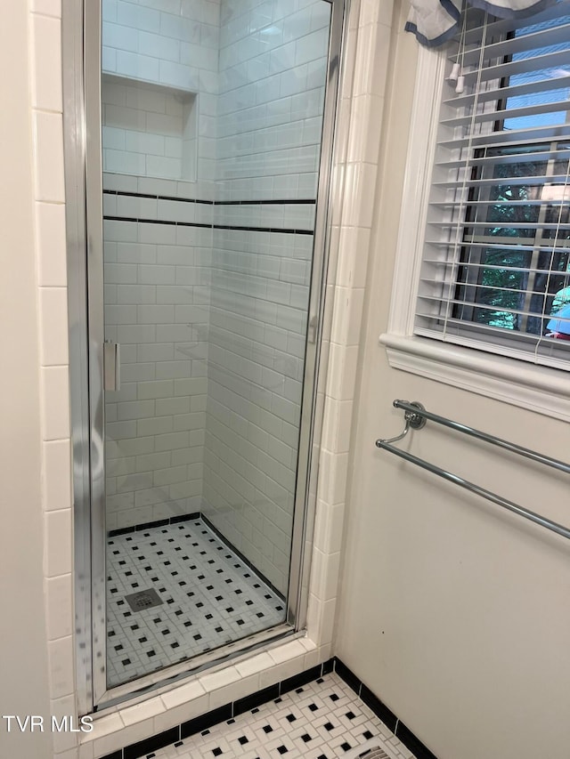 bathroom with tile floors and a shower with door