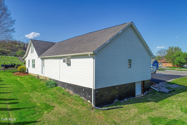 view of side of home featuring a lawn